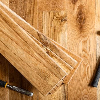 House renovation with changing of the floor from carpets to soli The process of house renovation with changing of the floor from carpets to solid oak wood. Different tools and materials on the new floor